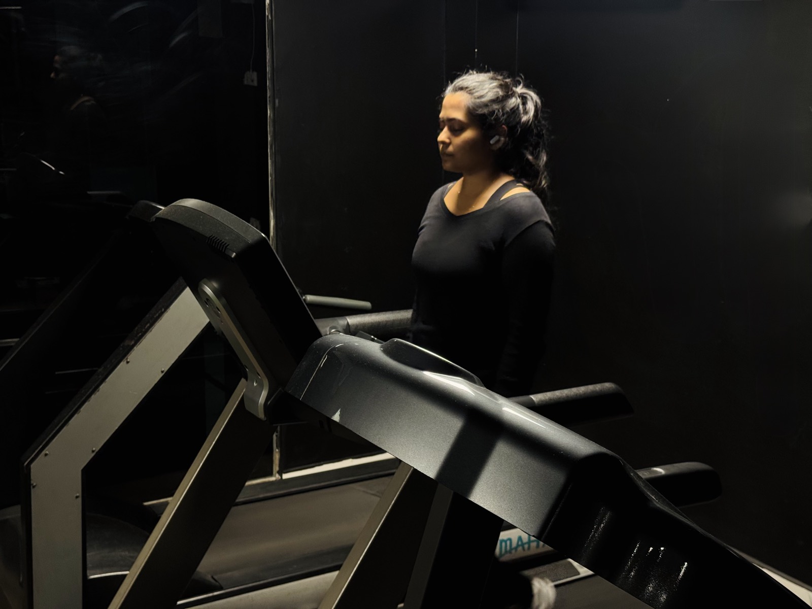 A member walking on a treadmill in the cardio area