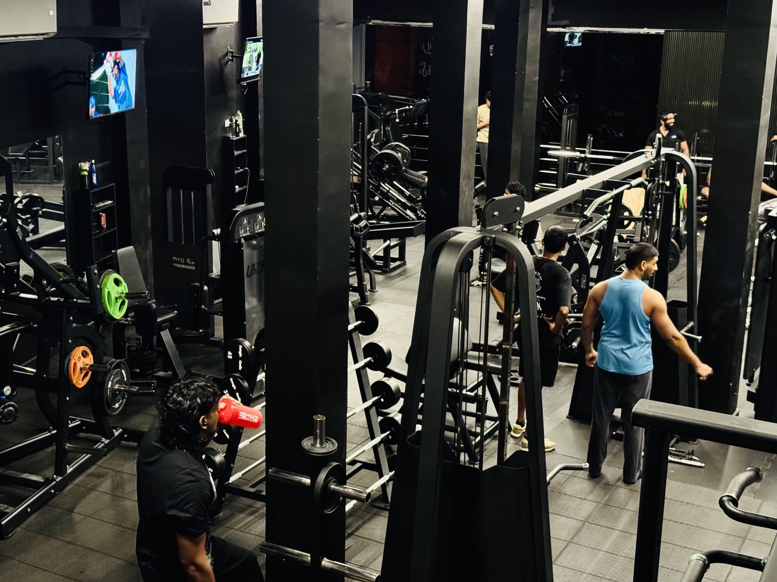 Cable machines and colour-coded plates along the training floor